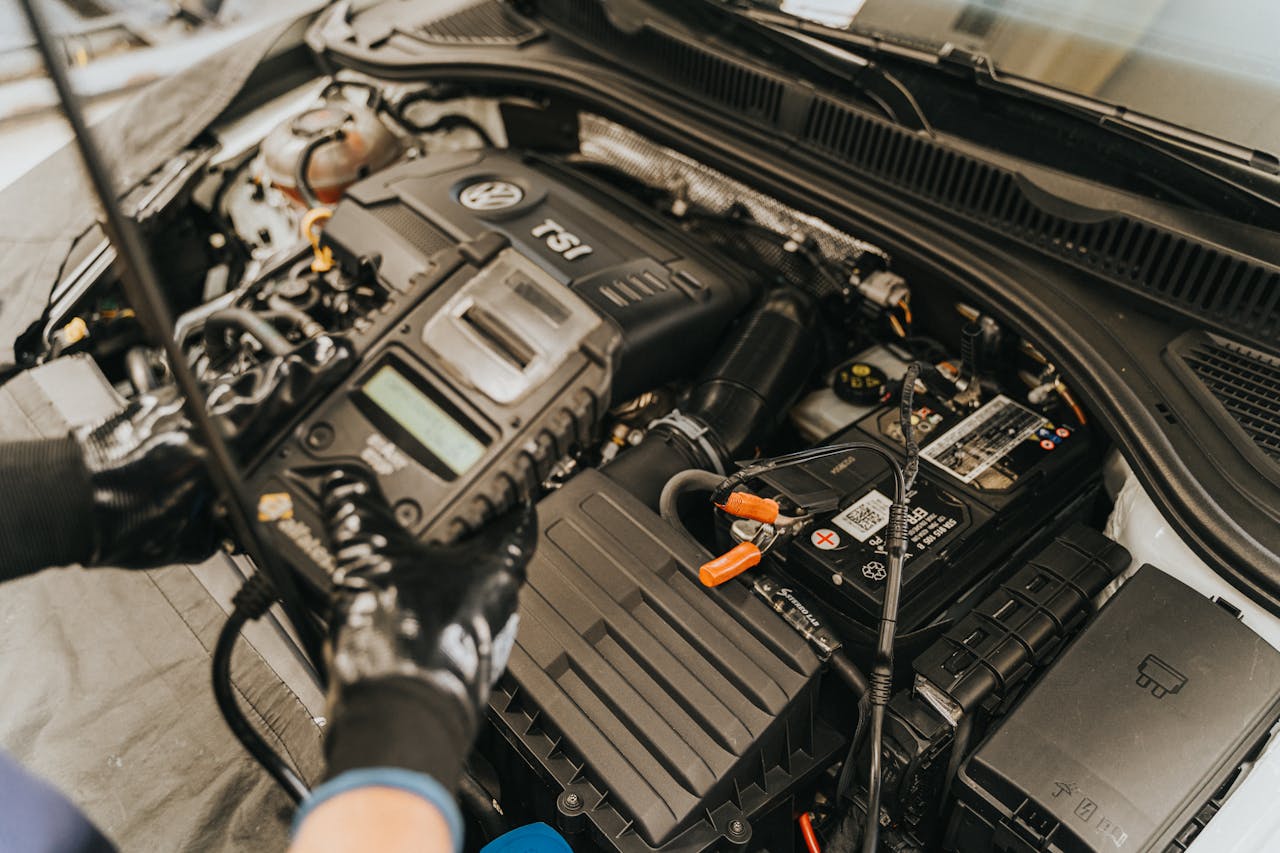 Services Close-up view of a mechanic diagnosing a Volkswagen engine with specialized equipment.